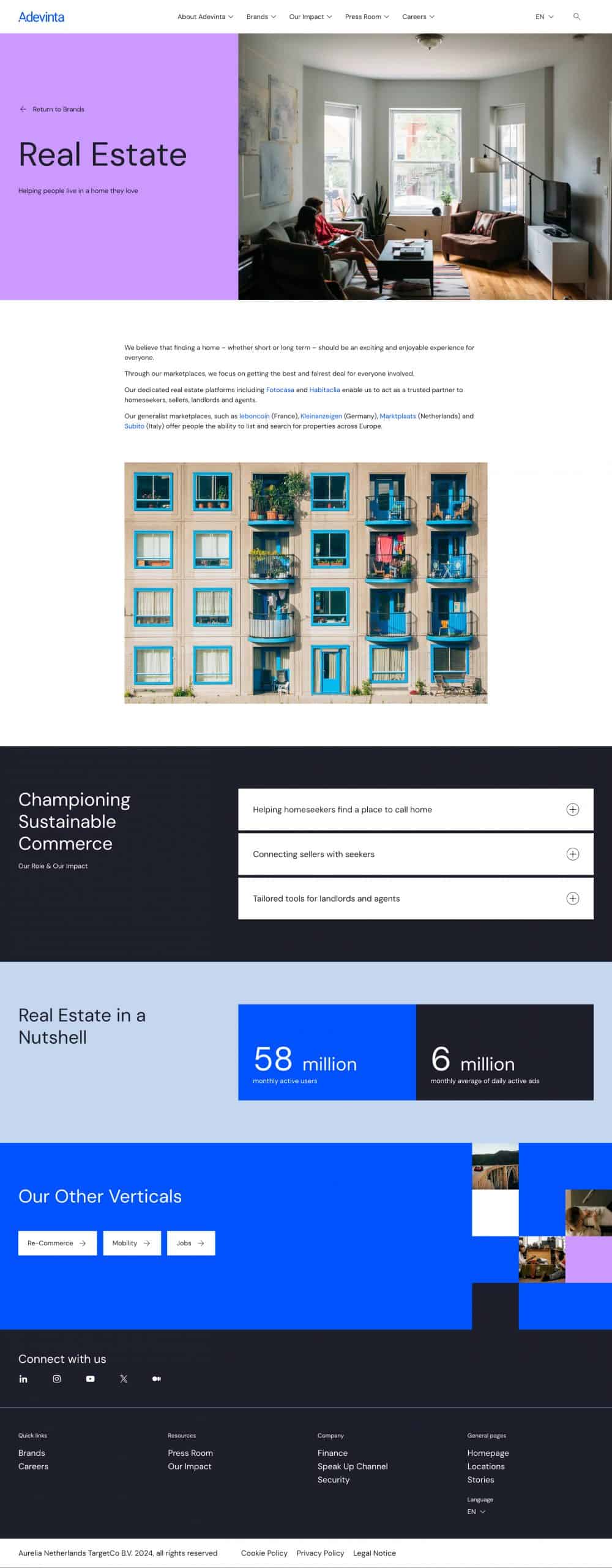 Modern apartment building with balconies and blue window frames.
