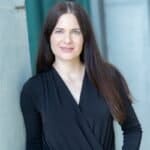 Professional woman in black blazer for business and office photography.