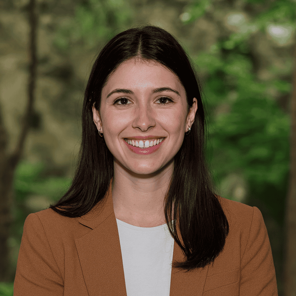 Confident woman smiling outdoors in business attire, representing professional success and entrepreneurship at SOHO.