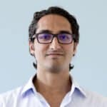 Modern professional wearing glasses in business setting.